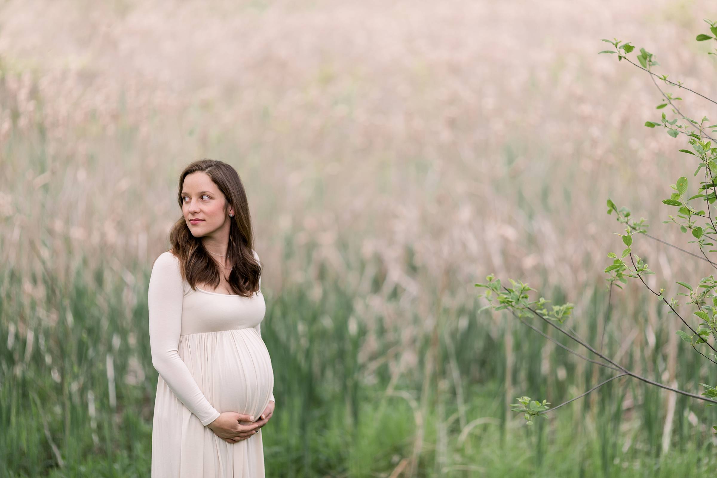 Pregnant woman in a field of tall grasses
